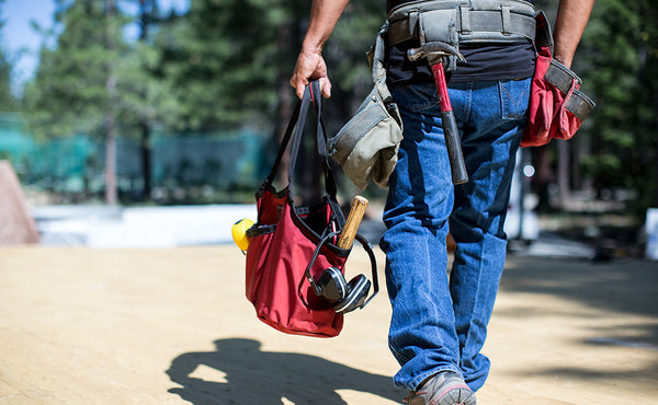 A person carrying The Truck filled with tools.
